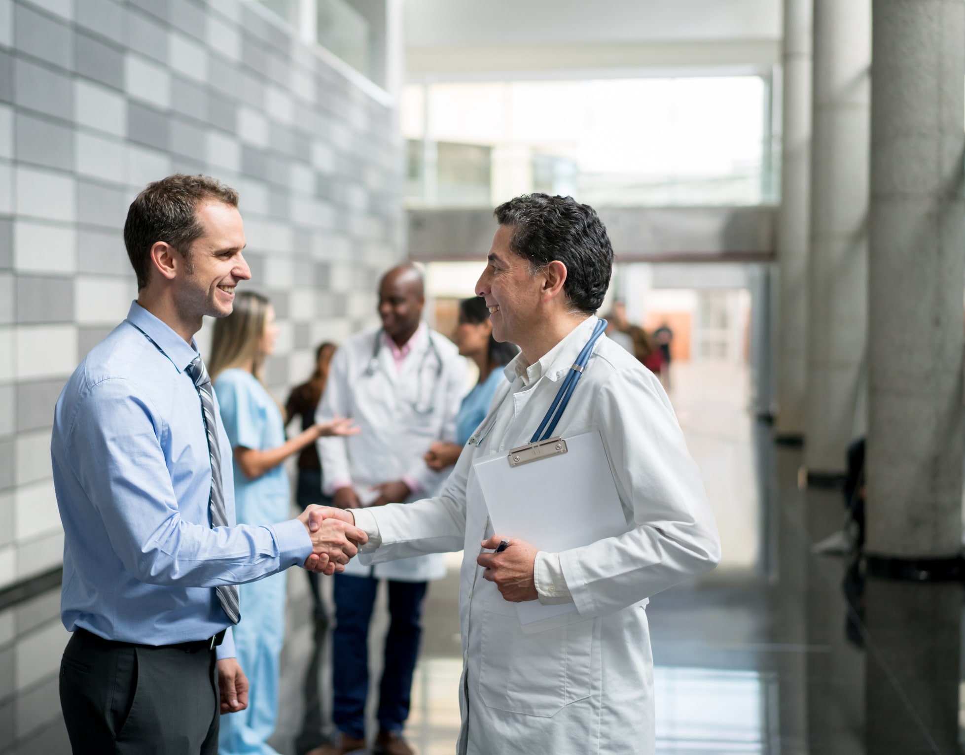healthcare consultant and doctor shaking hands