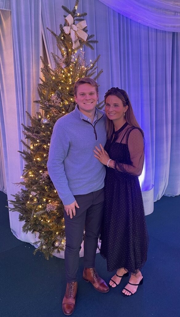 Kyle and his date in front of Christmas tree